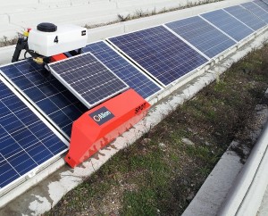 The Alion Energy cleaning robot “Spot” connects to the concrete foundation’s mounting rail to clean each module man-free.