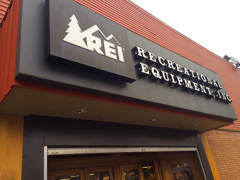 An REI co-op storefront sign.